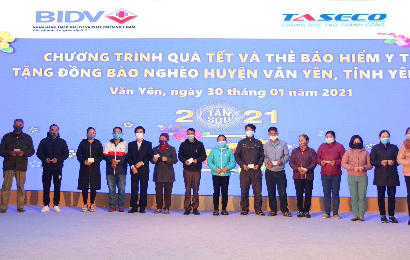 Ông Phạm Đức Long – Phó Tổng Giám đốc Taseco Group (đứng thứ 5 từ trái sang) đã trực tiếp trao tặng quà Tết và thẻ bảo hiểm y tế năm 2021 tới những người dân thuộc hộ nghèo.